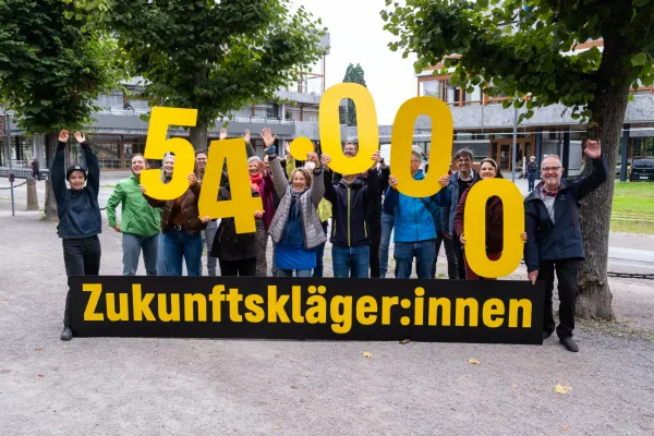 Eine Gruppe von Menschen steht vor dem Bundesverfassungsgericht, vor ihnen ein Banner mit der Aufschrift Zukunftsklägerinnen